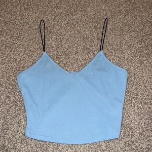 blue cropped tank top with black leather straps